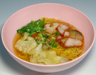 A captivating image of a bowl of noodles, beautifully presented with a variety of fresh ingredients and garnishes. The rich textures and vibrant colors make it an enticing visual for food enthusiasts