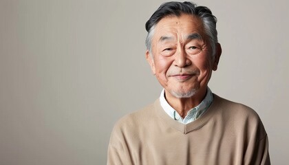 Obraz premium smiling Asian man 60 year old on light background with copy space