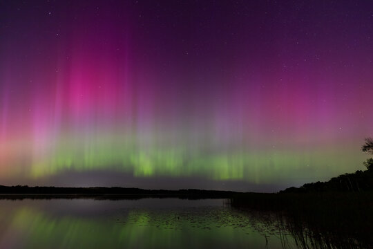 Enchanting Aurora Borealis Illuminates Typo Lake in Stacy, Minnesota - A Tranquil Nightscape of Colorful Reflections and Celestial Beauty