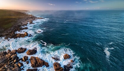 Aerial view of the ocean rocky shore Capturing the raw beauty and power of nature with the contrast between land and sea