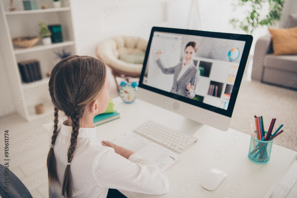 Wall mural Photo of small girl study watch computer screen teacher desktop apartment indoors