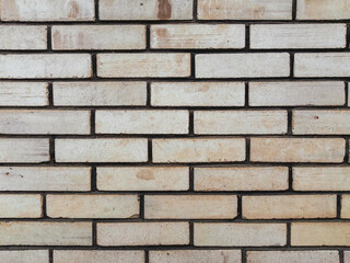 A brick wall with a white brick pattern