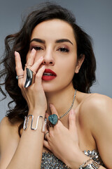 Obraz premium Beautiful woman elegantly poses, highlighting her radiant jewelry.