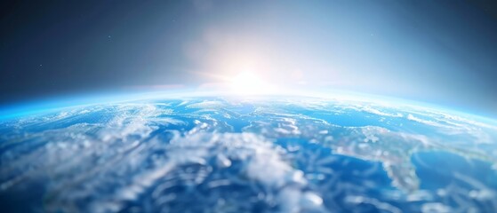  A perspective of Earth from space, sun glowing above cloud cover, Earth in foreground