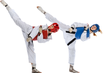 Legs kick. Dynamic portrait of two young women, taekwondo practitioners training isolated on transparent background. Concept of sport, education, skills, combat sport, martial arts