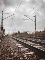 A train track with a cloudy sky in the background