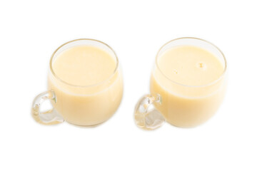 Organic non dairy banana and soy milk in glass isolated on white