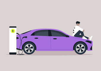 A person sits on the hood of a vibrant electric car, taking a break as the vehicle charges in an inviting urban environment