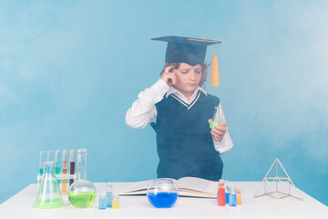 Photo of smart clever intelligent charming boy decide solve chemical research isolated on blue color background