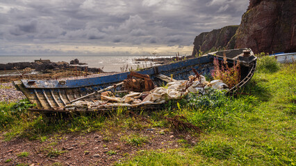 Remains of a boat near the beach in Auchmithie, Scotland, UK