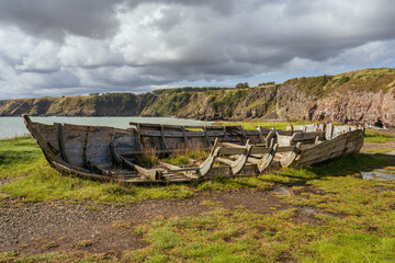 Remains of boats on the North Sea coast of Boddin, Scotland, UK