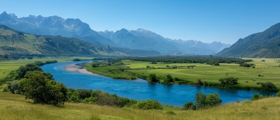  A river runs through a verdant valley, surrounded by lush green grass and mountains The valley is blanketed with greenery