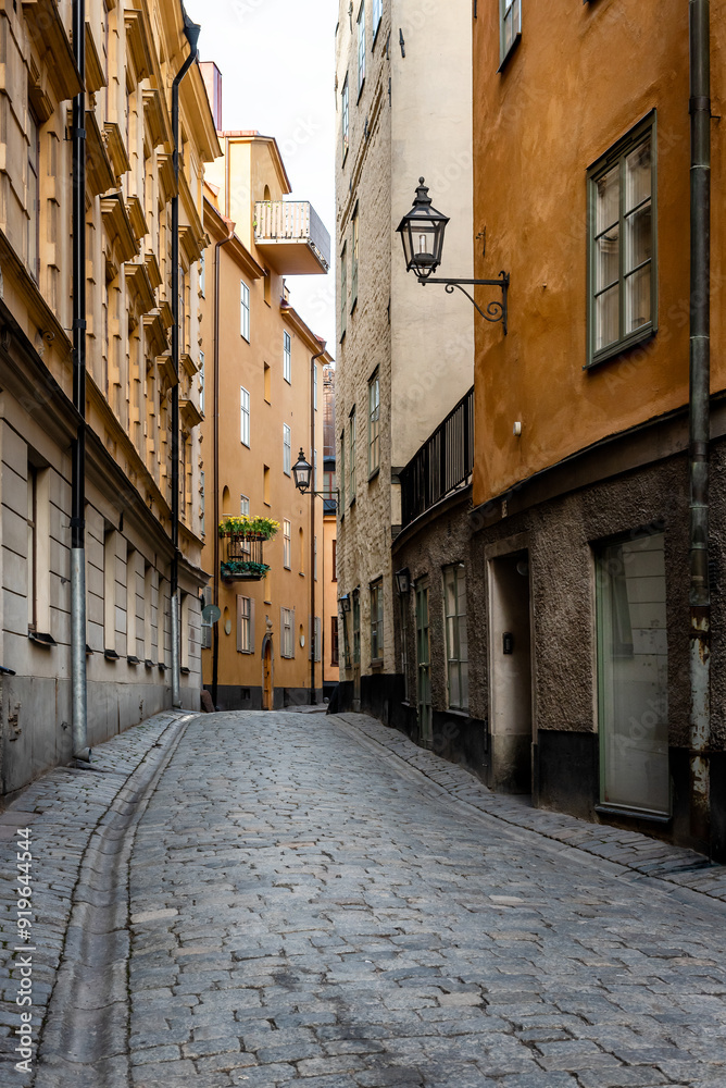 Wall mural sweden quaint cobblestone street in picturesque gamla stan, stockholm's oldest neighborhood.