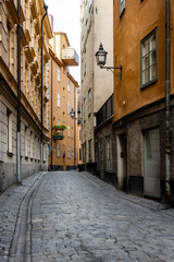 Fototapeta premium Sweden quaint cobblestone street in picturesque Gamla Stan, Stockholm's oldest neighborhood.