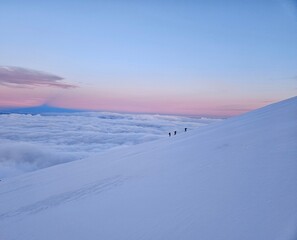 Sunrise on snow covered mountain (Mount Hood) with mountain shadow in background
