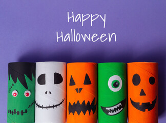 A group of paper tubes with Halloween faces on them