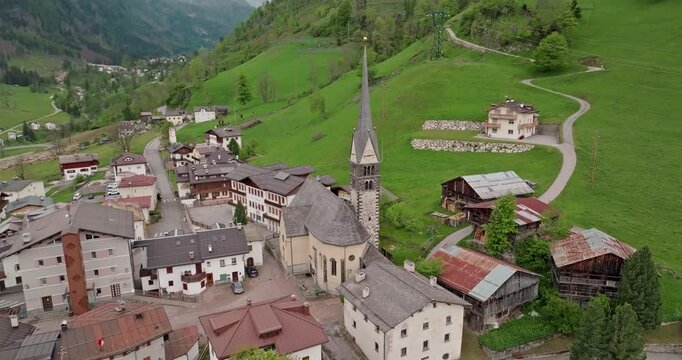 Aerial view of the alpine rural landscape of Rocca Pietore in Italy. Beautiful historical architecture of buildings in the Dolomite Alps. High quality 4k footage