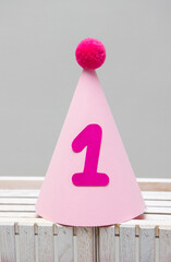 pink cardboard hat with pompom for birthday 1 year old