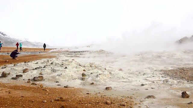 HVERIR GEOTHERMAL AREA, ICELAND - SEPTEMBER 20, 2018: A surreal geothermal area in North Iceland with steaming vents, bubbling mud pots, and colorful, alien-like landscapes.
