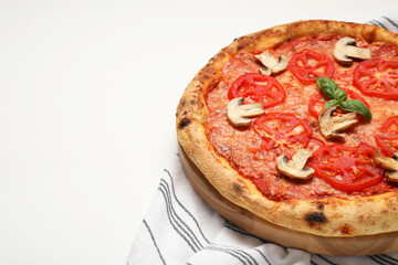 Delicious pizza with tomatoes, mushrooms and basil on white wooden table, closeup. Space for text