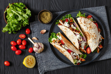 grilled chicken street tacos on a dark plate