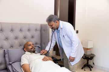 Doctor Conducting Home Check-Up with Elderly Patient
