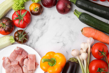 Different vegetables and raw meat for stew on white marble table, top view. Space for text