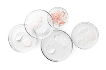 Petri dishes with different cosmetic products and leaves isolated on white, flat lay