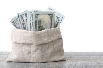 Dollar banknotes in bag on wooden table against white background, space for text