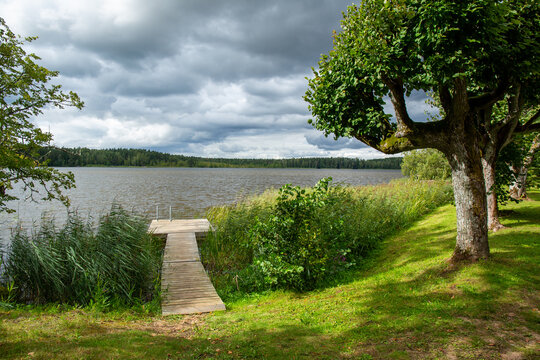 Wooden footbridge at the lake Katvari in August on a cloudy day in Katvari in Latvia