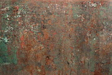 A rusty metal surface with a greenish tint