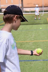 Two boys playing tennis on the local tennis court © Gosia