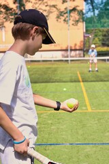 Two boys playing tennis on the local tennis court © Gosia