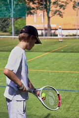 Two boys playing tennis on the local tennis court © Gosia