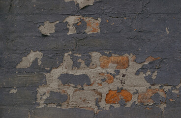 A brick wall with a few holes and cracks