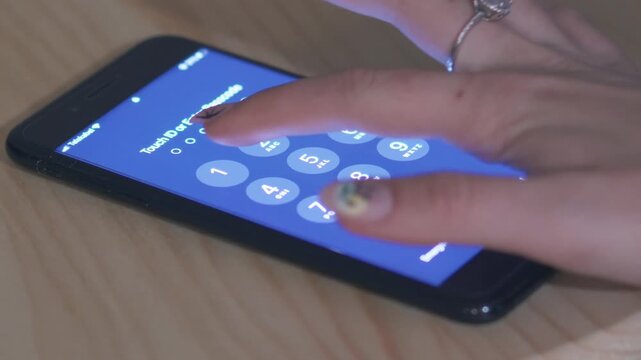 Skopje, Macedonia  - Mar 10, 2024: Person entering pin on a smartphone secure screen. Close-up image showing a hand entering a pin number on a smartphone's blue digital screen