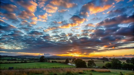 Fototapeta premium Golden Sunset Over Rolling Green Hills and Dramatic Clouds