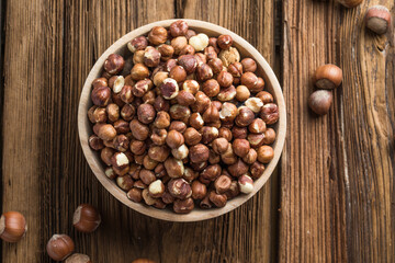 Full and peeled hazelnuts close-up. Macro photo of pile of filbert kernels