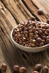 Full and peeled hazelnuts close-up. Macro photo of pile of filbert kernels