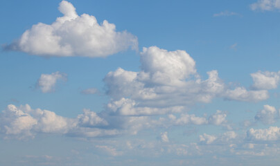Sky replacement puffy white clouds coming in under blue sky