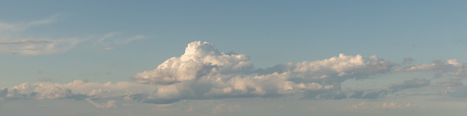 Sky replacement panoramic aqua sky with puffy clouds at horizon