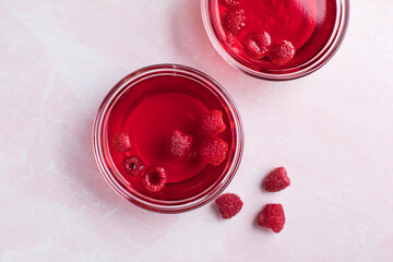 Healthy food. Raspberry jelly on white plate. Summer dessert with fruit jelly and fresh raspberry.