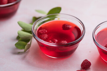 Healthy food. Raspberry jelly on white plate. Summer dessert with fruit jelly and fresh raspberry.