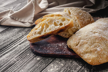 Ciabatta Italian bread with Olive Oil: Fresh, Rustic, Homemade, and Delicious on a Wooden Table
