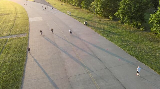 Footage of cyclists riding bikes at Tempelhof in Berlin on a spring day.