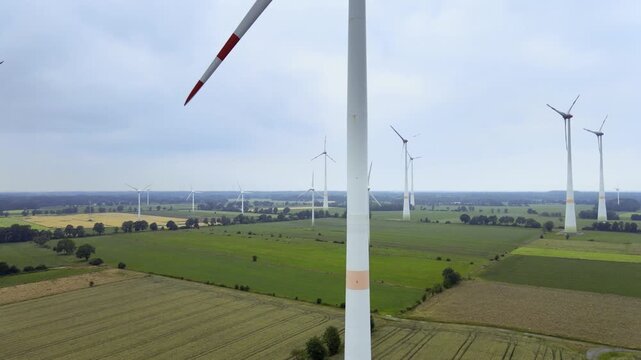 Aerial footage of wind turbines generating electricity in a vast field in Germany.