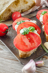 Italian Bruschetta on Ciabatta: Fresh Tomatoes, Garlic, and Olive Oil on a Wooden Table, Rustic