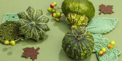 Autumn cozy composition. Crocheted leaves, pumpkins, berries, handmade, fall hobby concept