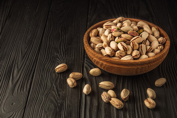 Cracked Pistachios: Healthy, Crunchy Nuts on Wooden and Black Backgrounds