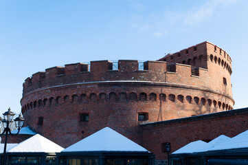 Brick fortress wall with a loophole for an artillery gun